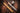 Gold tube engraved with initials and silver tube holding a cigar, the cap top engraved with a monogram