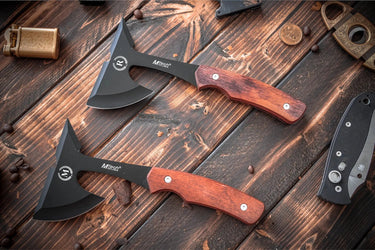 Two throwing axes with rosewood handles and black heads, each engraved with a monogram