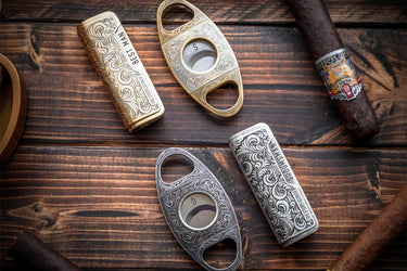 Antique bronze and antique silver cutter and lighter sets, each engraved with initials and a name