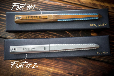 Gold and silver titanium EDC pens on gift boxes, a name on each cap in two font choices