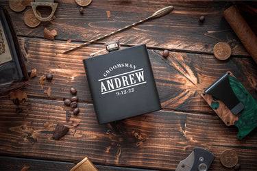 Black hip flask engraved with a title, a first name and a date